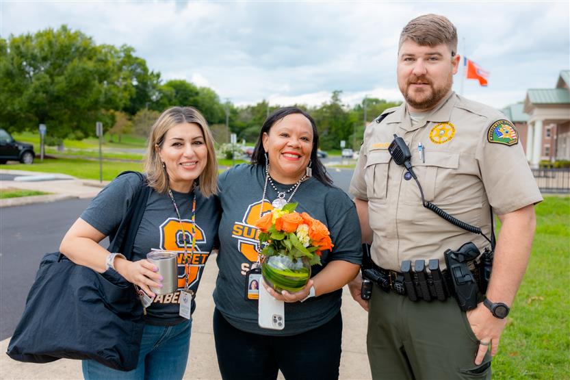 Students take a picture with a School Resource Officer